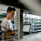 A maintenence worker at Bitmain monitors bitcoin mining machines.
